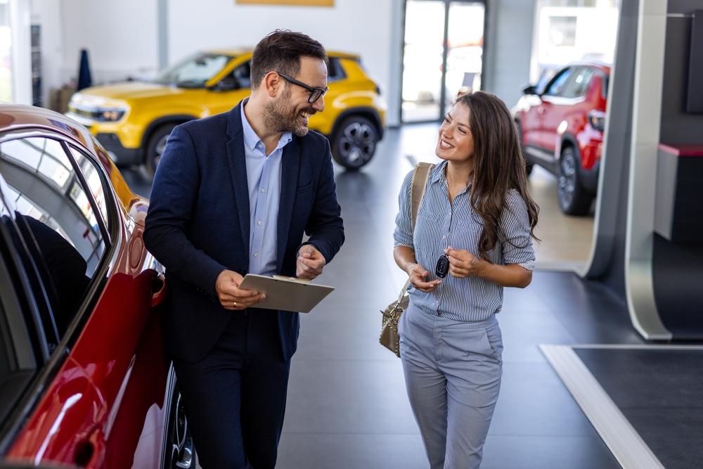 beautiful,young,woman,is,talking,to,handsome,car,dealership,worker beautiful,young,woman,is,talking,to,handsome,car,dealership,worker